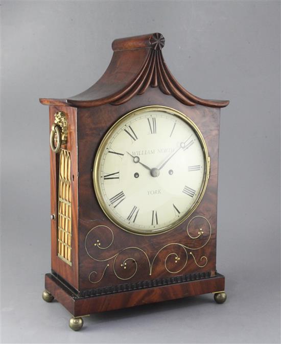 An early 19th century brass inlaid mahogany table clock and wall bracket An early 19th century brass inlaid mahogany table clock and wall bracket