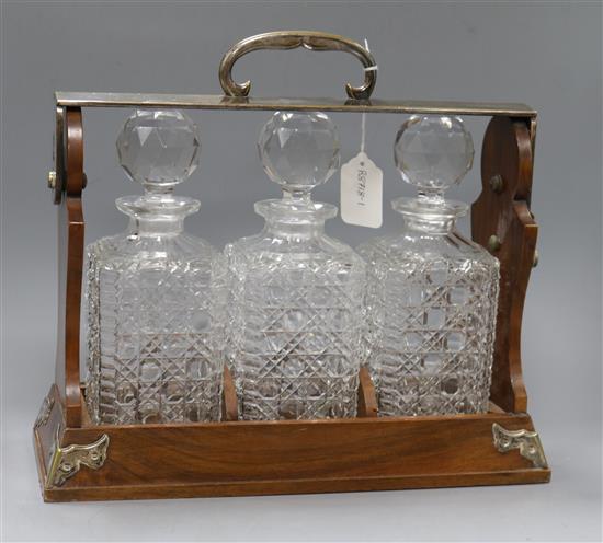A Betjemanns walnut three decanter tantalus, lacking keys A Betjemanns walnut three decanter tantalus, lacking keys