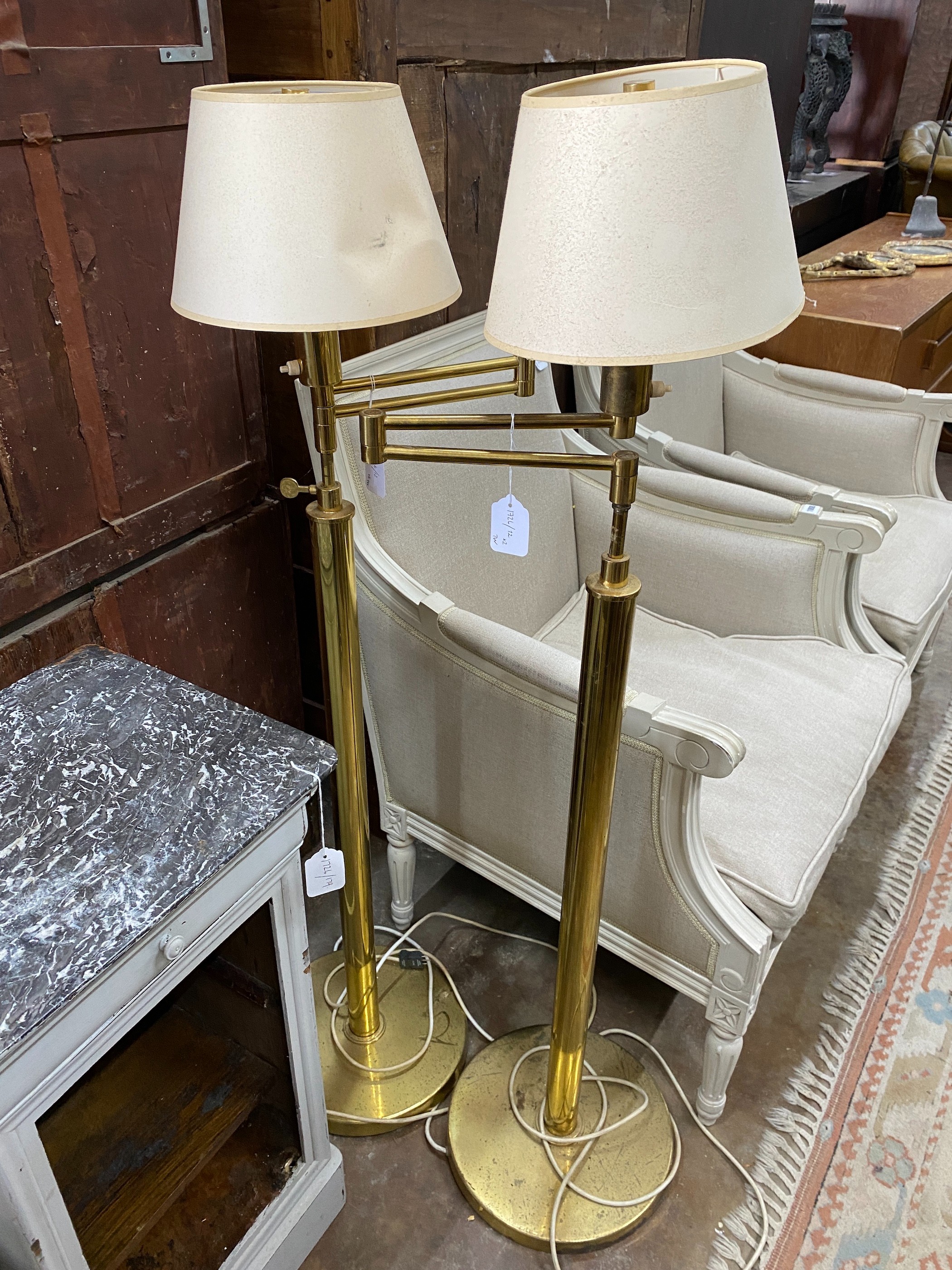 A pair of adjustable brass telescopic standard lamps