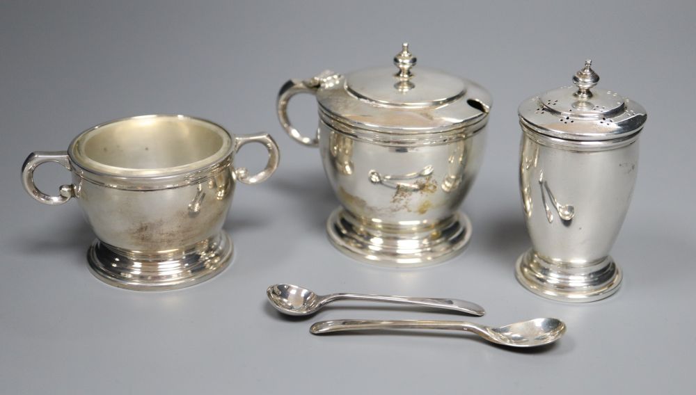 A modern cased silver three piece condiment set, with two later spoons, Wakely & Wheeler, London, 1957, 5oz.