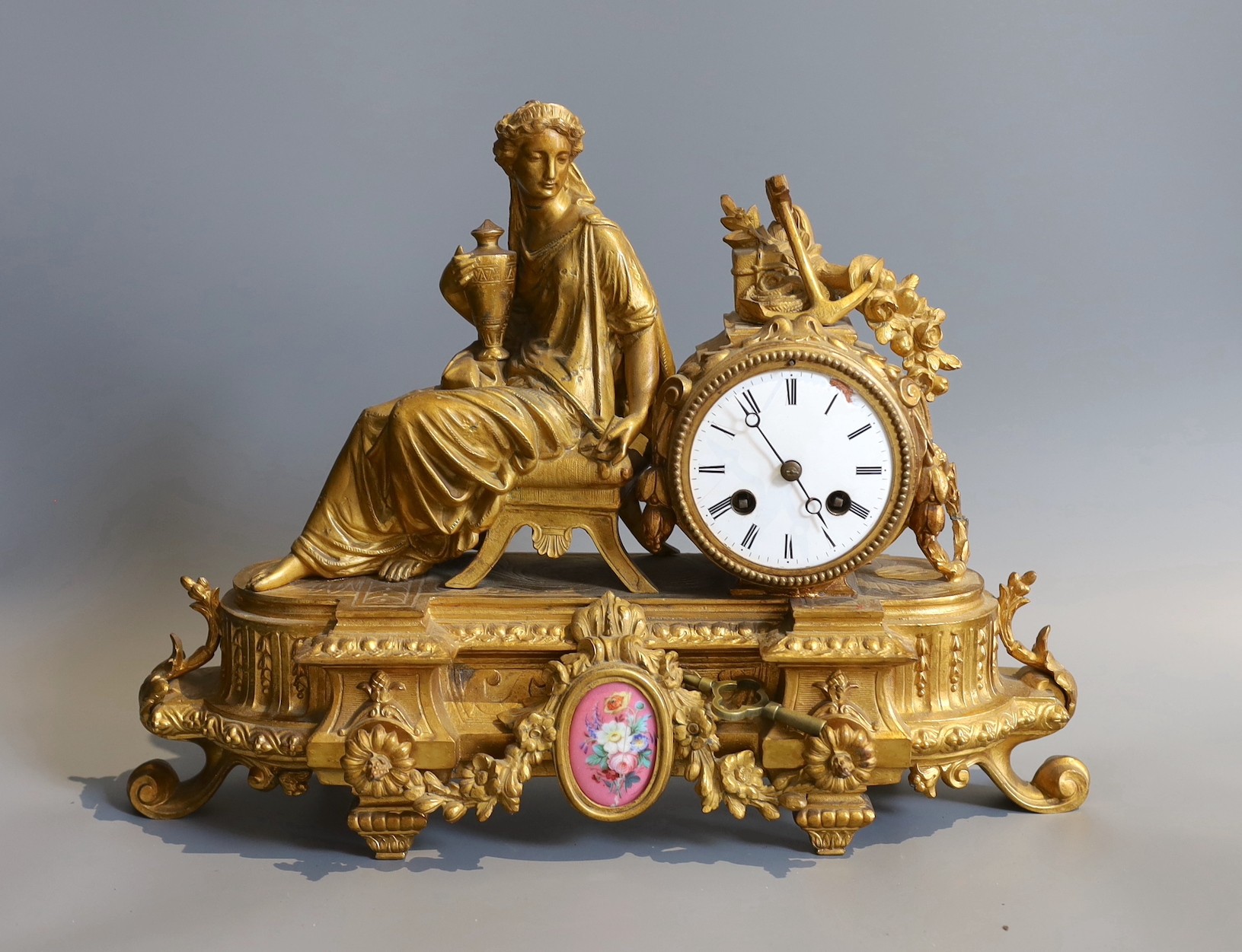 A 19th century French gilt spelter mantel clock, inset oval porcelain panel, height 30cm