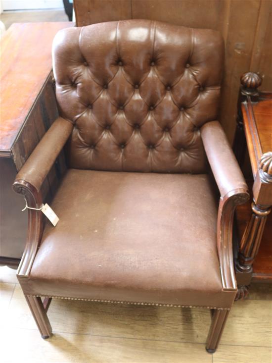 A leather button back elbow chair A leather button back elbow chair