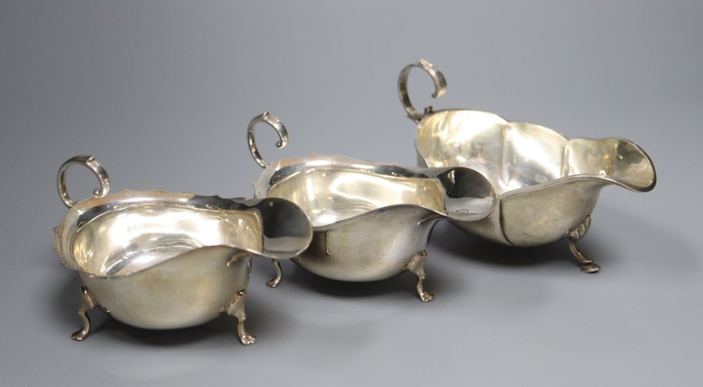 A pair of George V silver sauceboats, Barker Brothers, Chester, 1925 and one other earlier sauceboat,