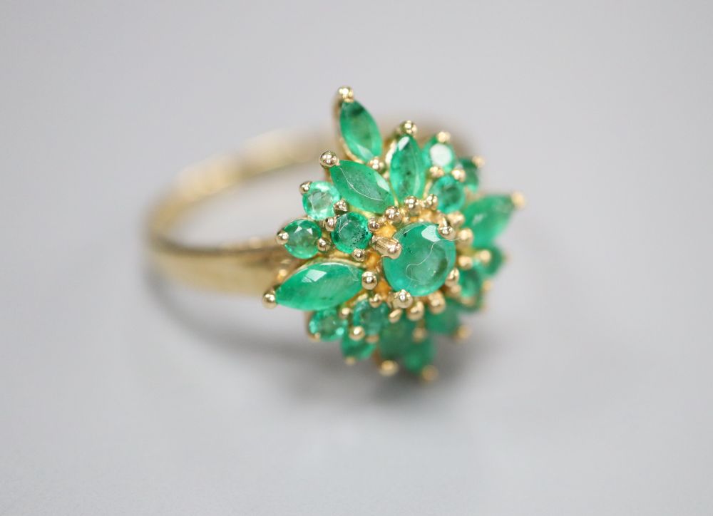 A modern 9ct gold and emerald cluster ring, size R, gross 3.4 grams.