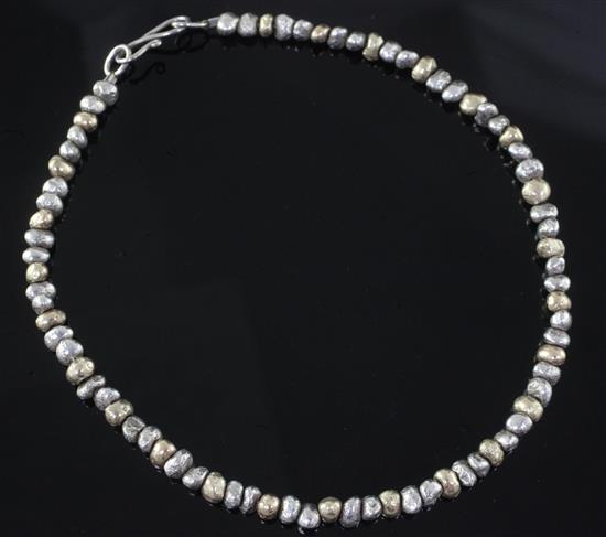 A modern gold and silver nugget necklace by Anton Pruden, Ditchling, 41cm. A modern gold and silver nugget necklace by Anton Pruden, Ditchling, 41cm.