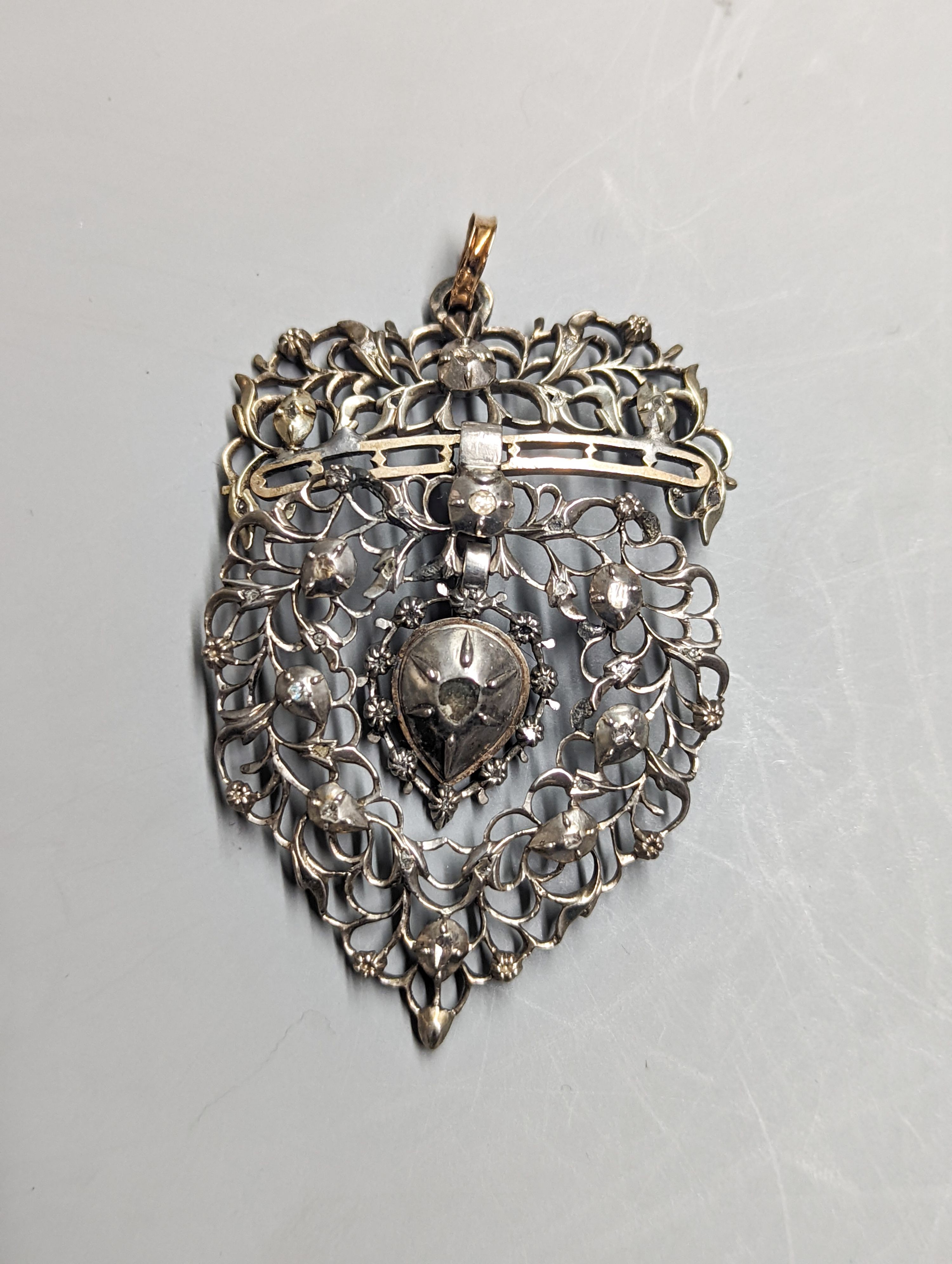 A late 19th century continental pierced white and yellow metal, rose cut diamond set heart shaped drop pendant, 62mm, gross weight 15.5 grams, in fitted box.