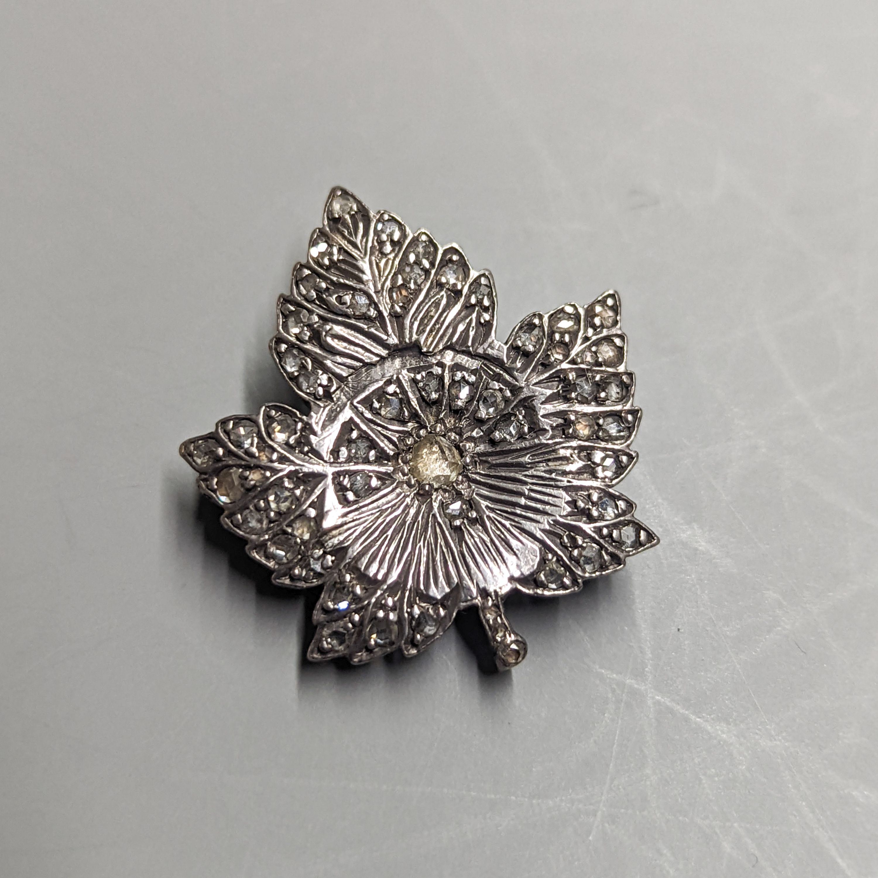 An early 20th century yellow and white metal, rose cut diamond set leaf brooch, 29mm, gross 7.4 grams (adapted?).
