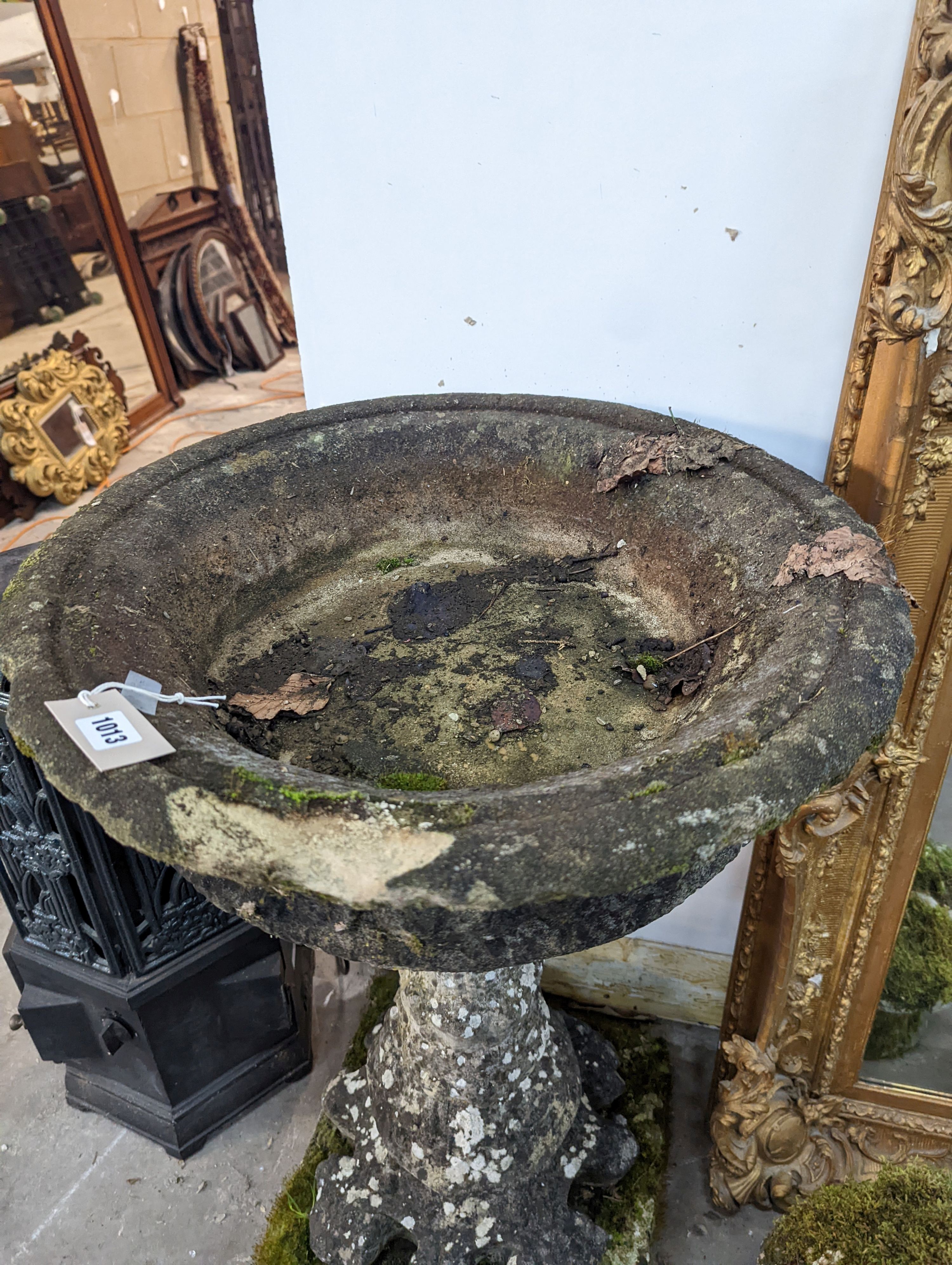 A circular reconstituted stone bird bath, diameter 56cm, height 89cm