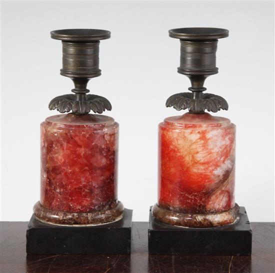 A pair of Regency bronze and red fluorospar / Blue John mounted candlesticks, 6.25in. A pair of Regency bronze and red fluorospar / Blue John mounted candlesticks, 6.25in.
