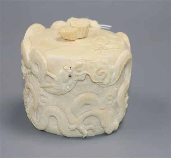 A Japanese Meiji period tusk box and cover carved with dragons with mother of pearl eyes, H 8cm A Japanese Meiji period tusk box and cover carved with dragons with mother of pearl eyes, H 8cm