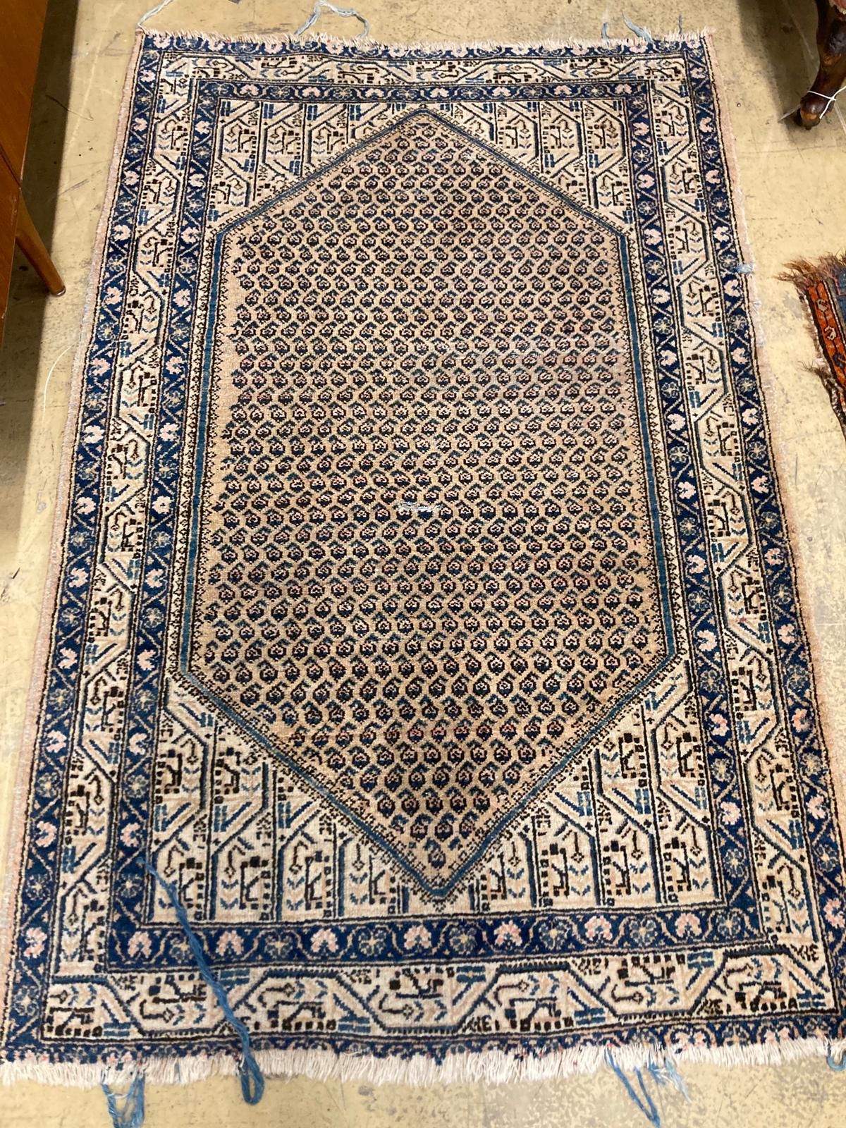 A North West Persian ivory ground rug, 188 x 120cm together with a smaller Afghan red ground rug