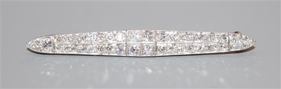 An early 20th century 15ct & Pt, diamond set twin row bar brooch, 57mm. An early 20th century 15ct & Pt, diamond set twin row bar brooch, 57mm.