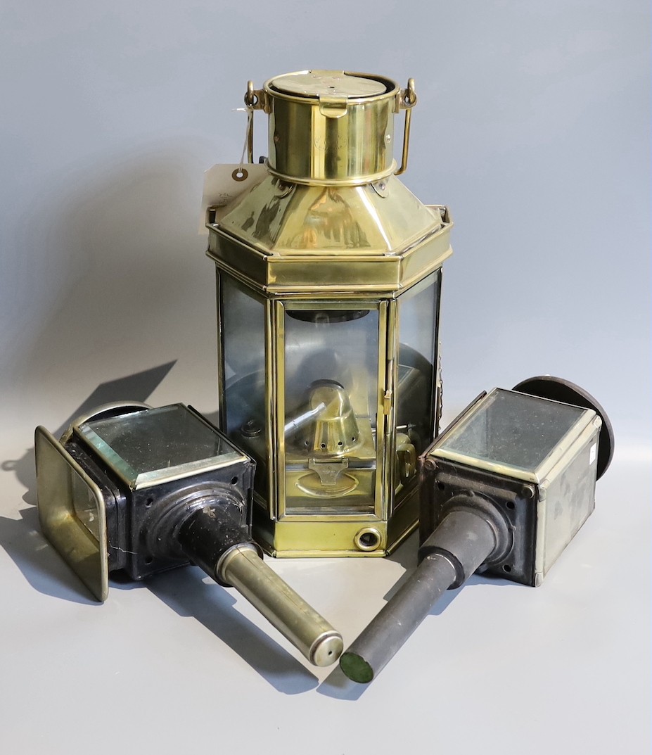 A Victorian brass carriage lamp, with turned wood handle, height 41cm, together with two other carriage lamps