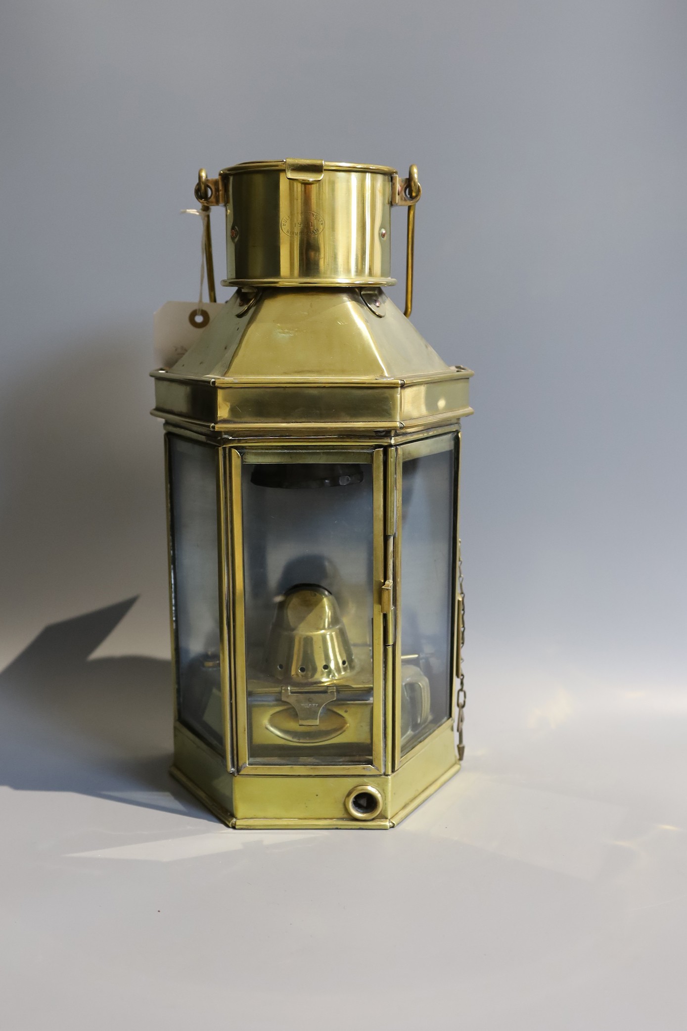 A Victorian brass carriage lamp, with turned wood handle, height 41cm, together with two other carriage lamps