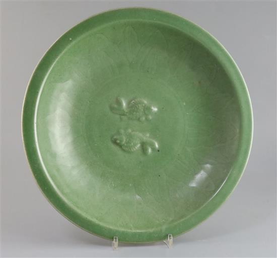 A Chinese celadon glazed twin fish dish, Qing dynasty, D. 34.5cm, wood stand A Chinese celadon glazed twin fish dish, Qing dynasty, D. 34.5cm, wood stand