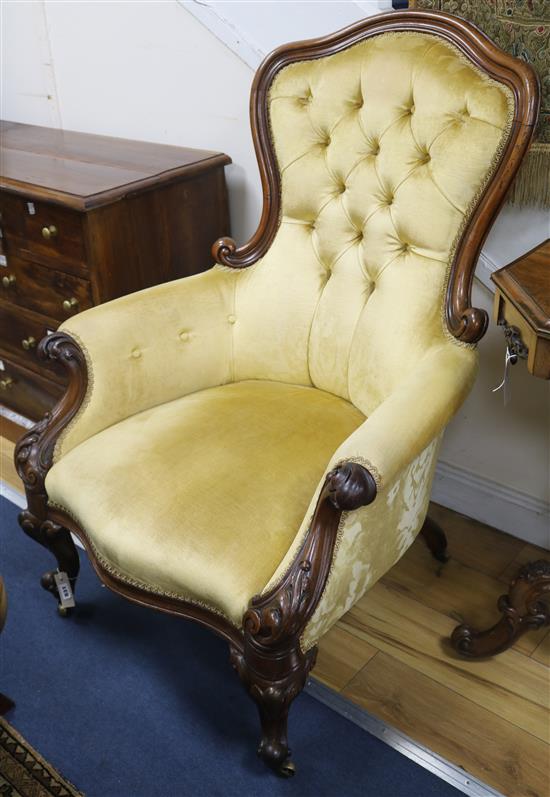 A Victorian mahogany buttonback armchair, upholstered in gold velvet A Victorian mahogany buttonback armchair, upholstered in gold velvet