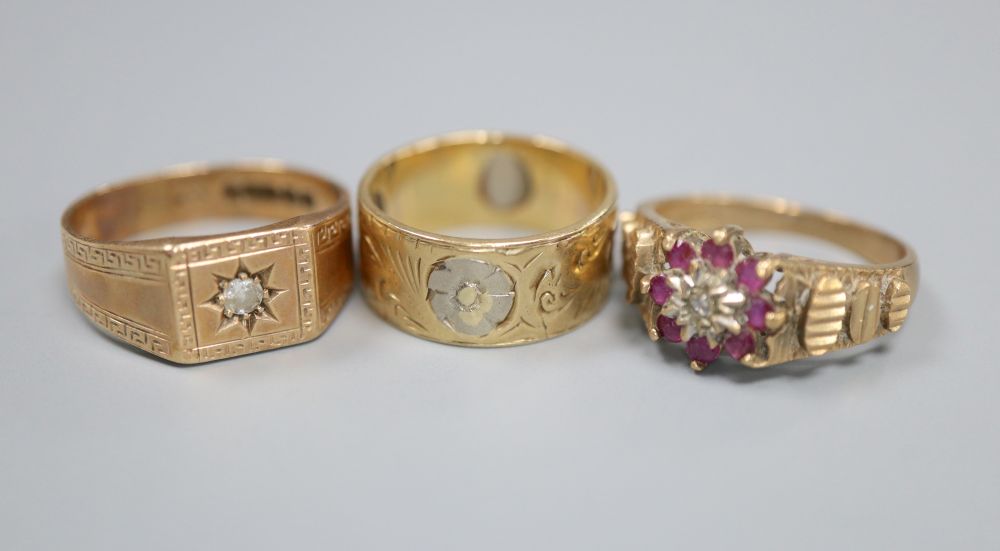A 9ct gold and diamond gypsy-set ring, a 9ct gold, ruby and diamond cluster ring and a two-colour 9ct gold engraved ring, 13.8g