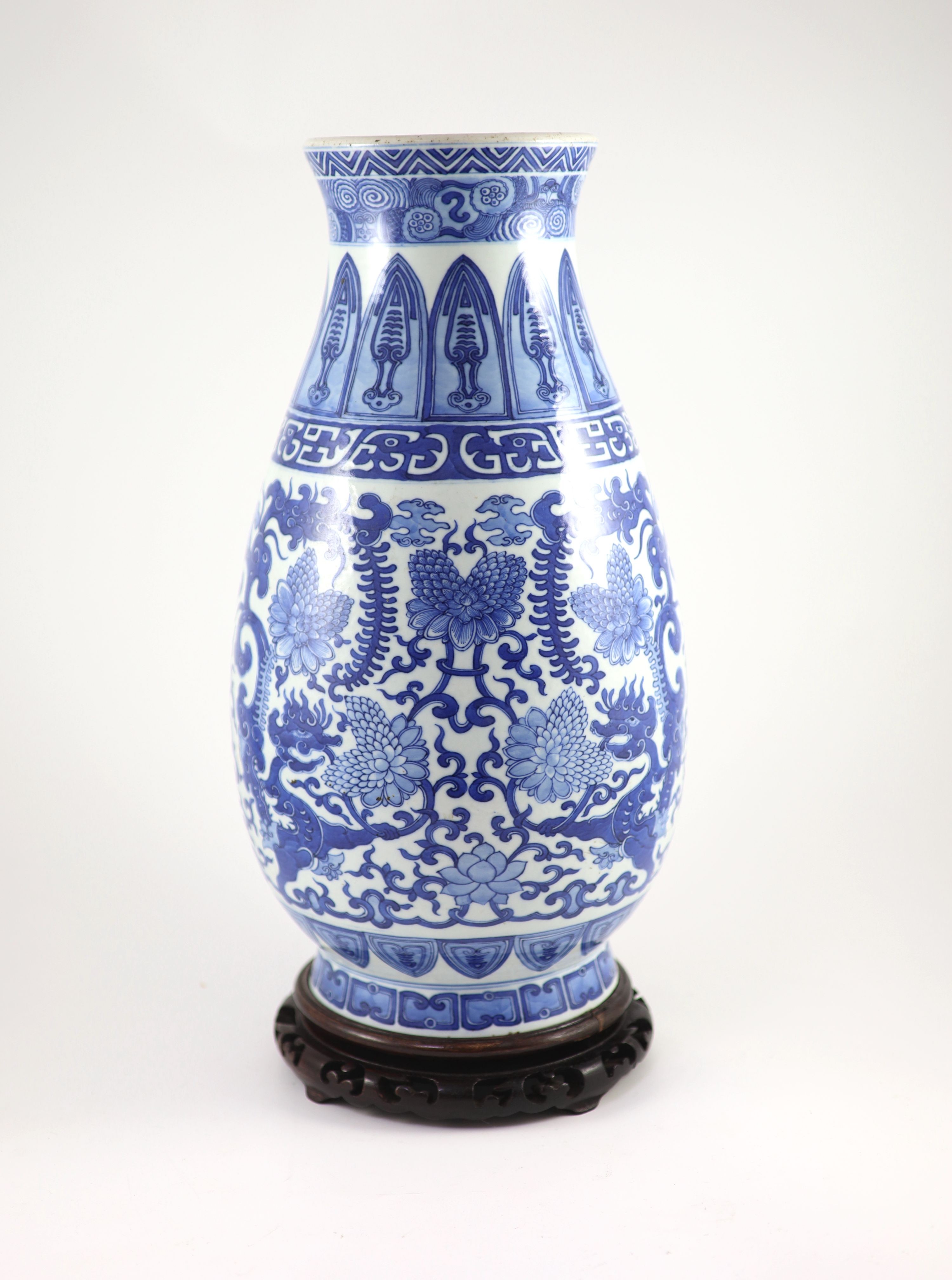 A Chinese archaistic blue and white pear-shaped vase, Qianlong mark but 19th century, 44.5 cm high, wood stand