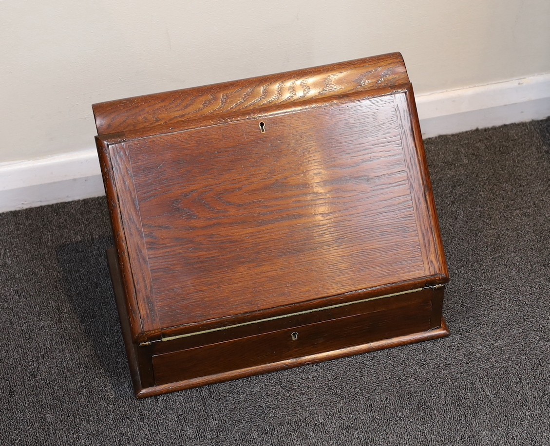 A late Victorian oak writing casket, with hinged slant front, width 36cm