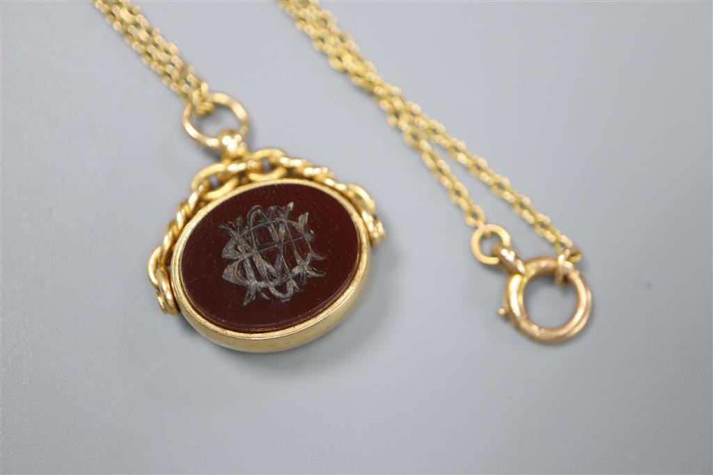 A late Victorian 18ct gold, carnelian and bloodstone set spinning fob seal, on a 15ct chain,