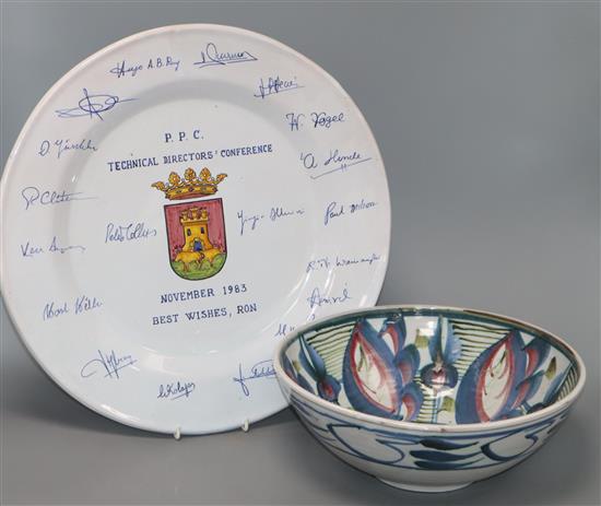 A pottery bowl decorated with stylised flowers in pink, blue and green (signed to base) and a large Talavera presentation charger A pottery bowl decorated with stylised flowers in pink, blue and green (signed to base) and a large Talavera presentation charger