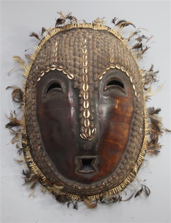 A Solomon Islands turtle shell mask, applied with shells and feathers ...