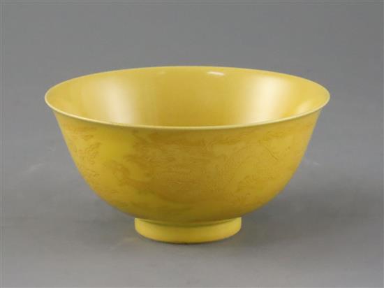 A Chinese yellow glazed sgraffito dragon bowl, Qianlong seal mark and of the period (1736-95), Diam.13.3cm, restored A Chinese yellow glazed sgraffito dragon bowl, Qianlong seal mark and of the period (1736-95), Diam.13.3cm, restored