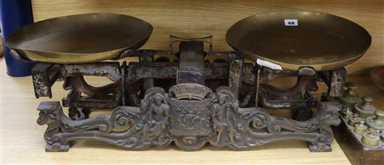 Large metal kitchen scales and a set of brass weights Large metal kitchen scales and a set of brass weights