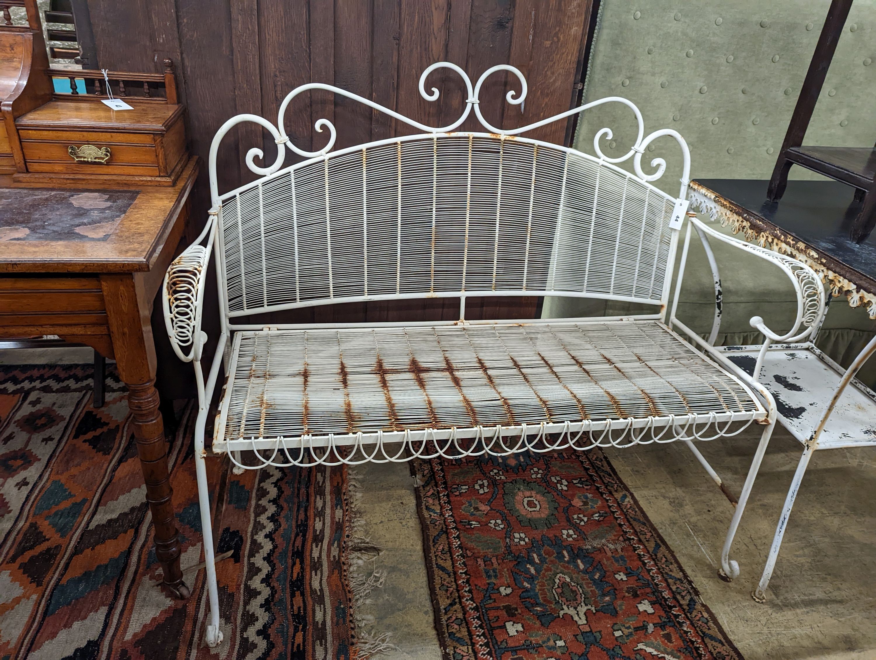 A French painted metal folding garden bench, length 114cm, depth 45cm, height 97cm together with a rectangular metal garden table