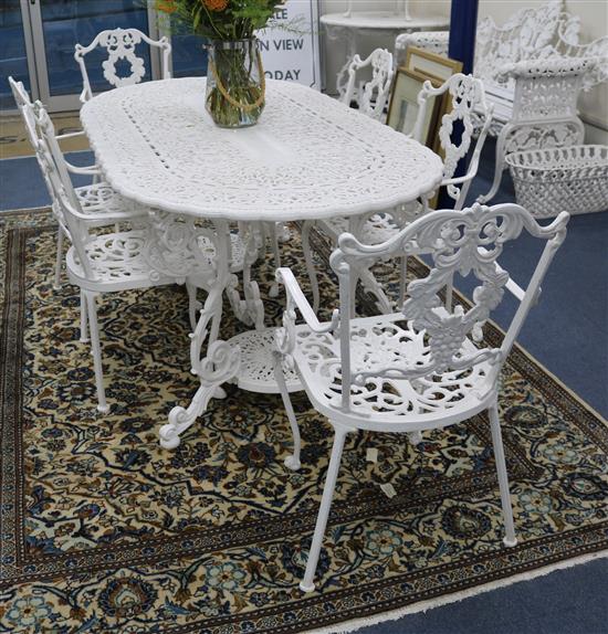 A white painted cast iron garden table and six chairs w.170cm A white painted cast iron garden table and six chairs w.170cm