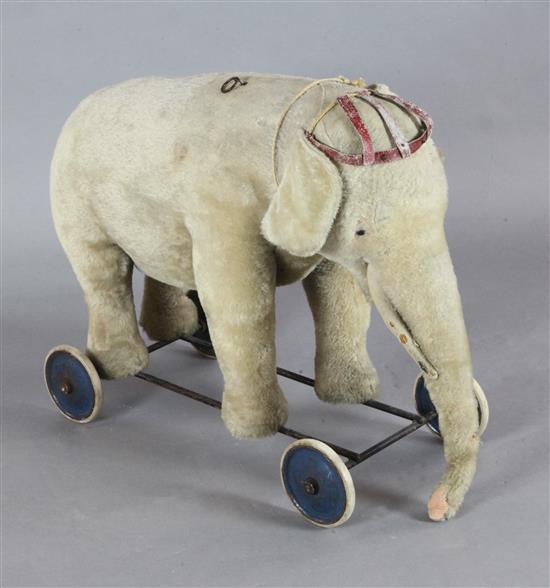 A Steiff pale gold plush pull along elephant, length 29in. A Steiff pale gold plush pull along elephant, length 29in.