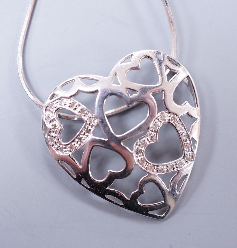 A modern 9k white metal and diamond chip set open work heart pendant, 26mm, on a 9ct white gold fine chain, 43cm, gross weight 5 grams