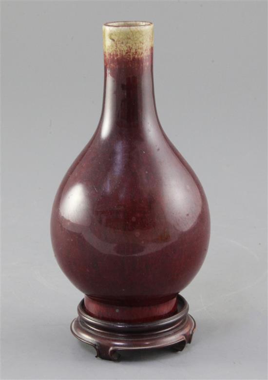 A Chinese Langyao sang de boeuf glazed bottle vase, 18th century, height 15cm. wood stand A Chinese Langyao sang de boeuf glazed bottle vase, 18th century, height 15cm. wood stand