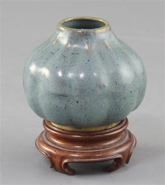A Chinese Jun-type lobed ovoid vase, 17th/18th century, height 6cm, wood stand A Chinese Jun-type lobed ovoid vase, 17th/18th century, height 6cm, wood stand