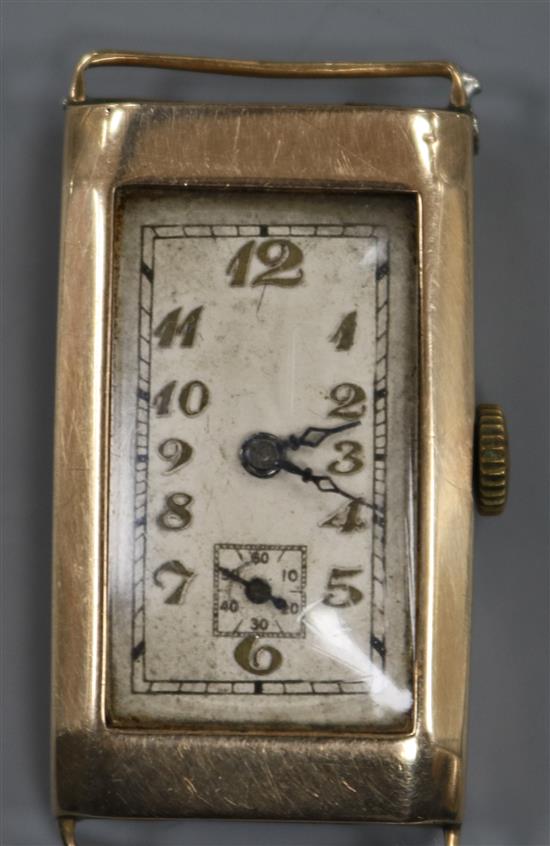 An early 20th century 9ct gold rectangular cased manual wind wrist watch, (no strap). An early 20th century 9ct gold rectangular cased manual wind wrist watch, (no strap).