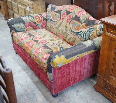 An early 20th century carpet upholstered scroll arm two seater settee, length 150cm, depth 80cm, height 80cm