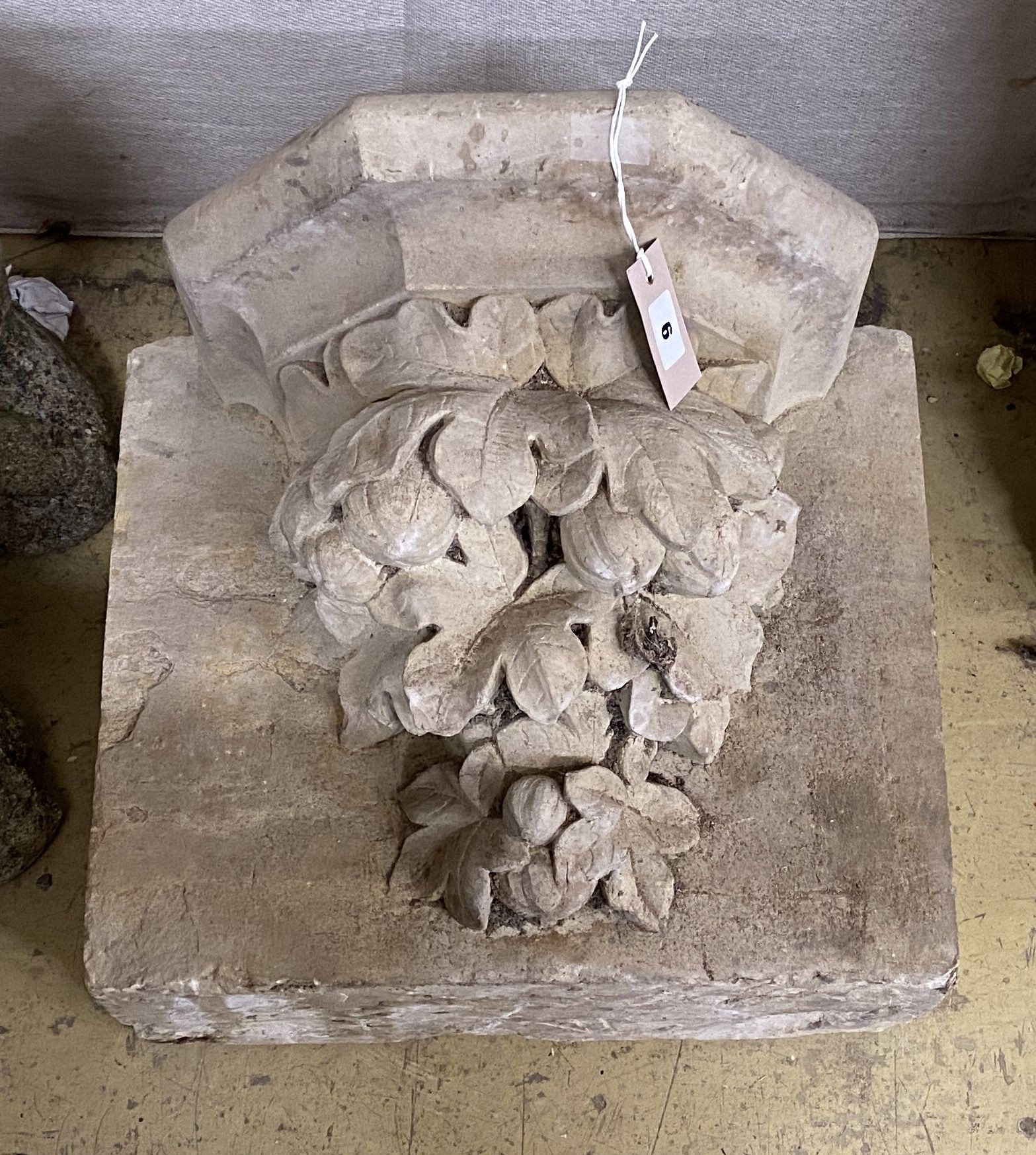 A carved simulated limestone corbel, width 42cm, height 35cm