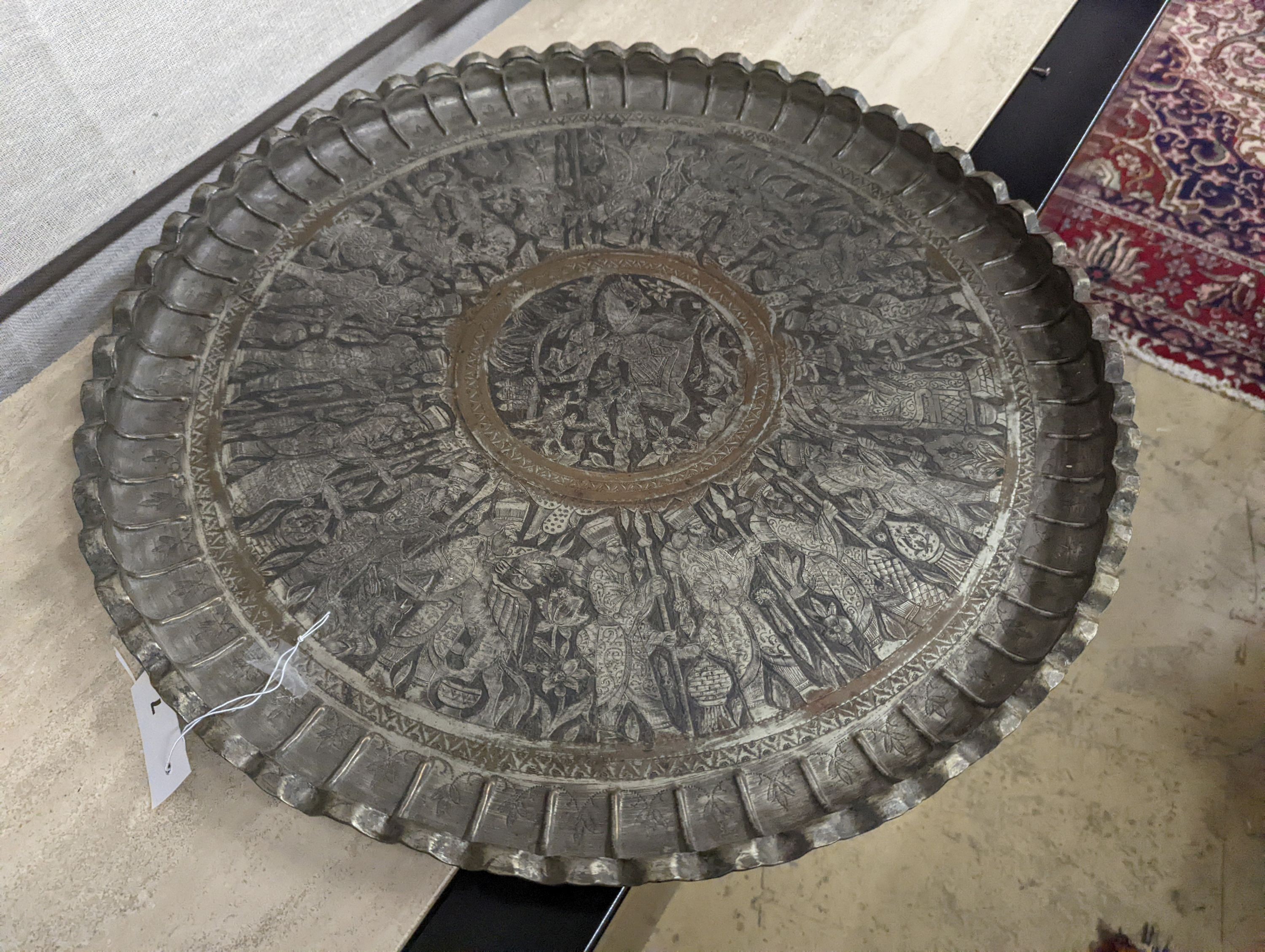 A Persian engraved circular tray, diameter 67cm