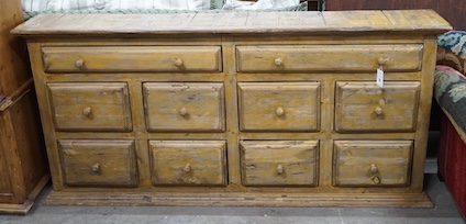 A 19th century style provincial bank of ten painted pine drawers, width 179cm, depth 26cm, height 85cm