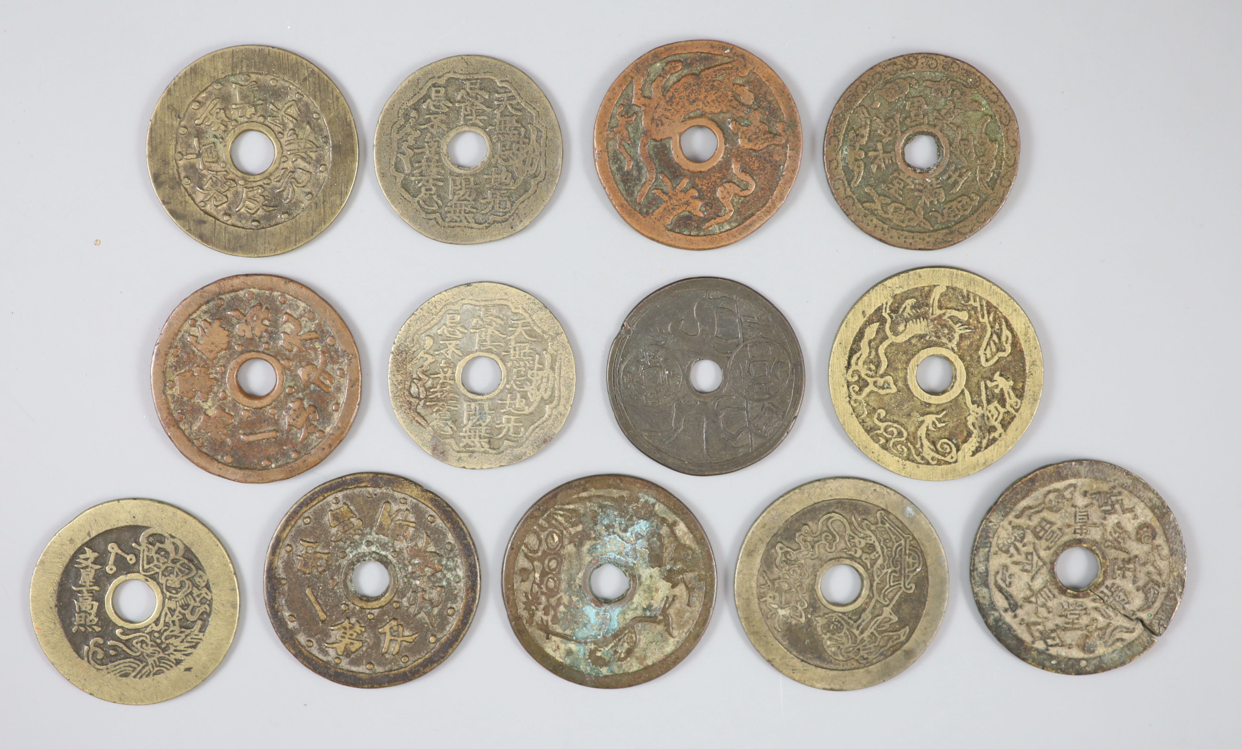 China, 13 cast bronze charms or amulets, Qing dynasty,