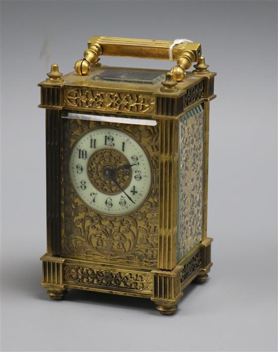 An ornate brass carriage timepiece An ornate brass carriage timepiece