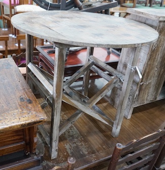 A French provincial pine circular table on folding underframe, diameter 77cm, height 72cm