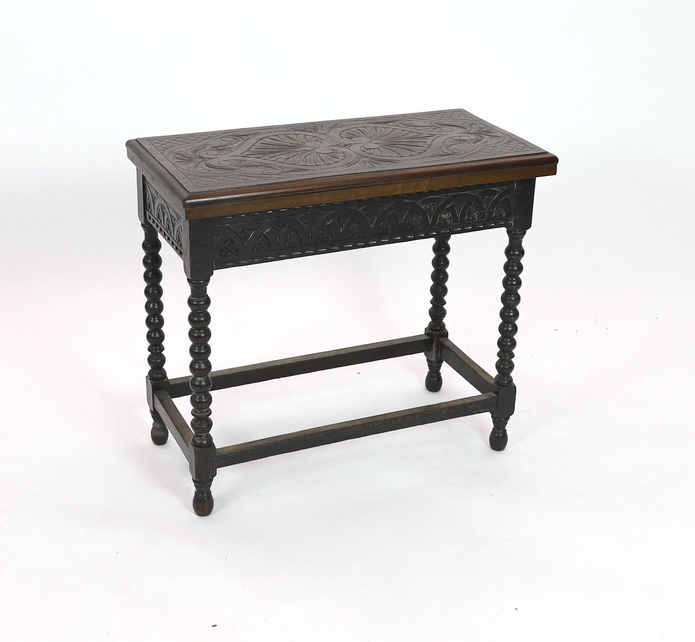 An early 20th century Jacobean revival rectangular carved oak folding card table, on bobbin turned legs, width 80cm depth 40cm height 73cm