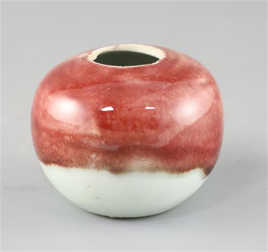 A Chinese copper red and white glazed globular water pot, 18th / 19th century, H.7cm Diam.9cm, firing crack to rim A Chinese copper red and white glazed globular water pot, 18th / 19th century, H.7cm Diam.9cm, firing crack to rim