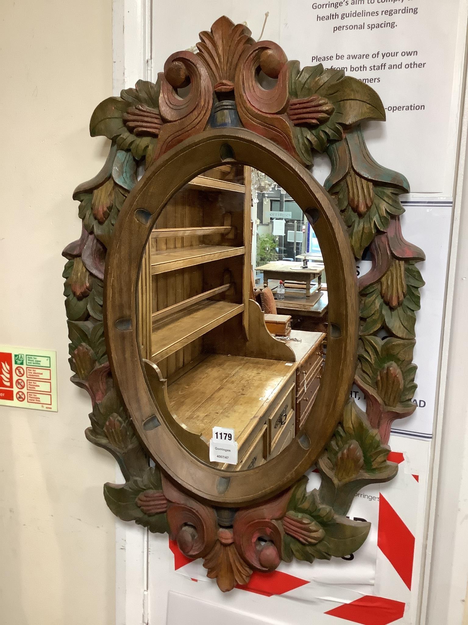 A Victorian style oval polychrome carved wood mirror width 50cm, height 78cm