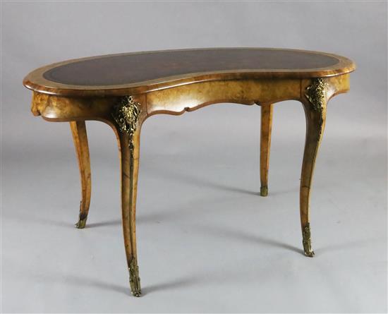 A Victorian crossbanded walnut kidney shaped writing table, W.4ft 3in. D.2ft 3in. H.2ft 6in. A Victorian crossbanded walnut kidney shaped writing table, W.4ft 3in. D.2ft 3in. H.2ft 6in.