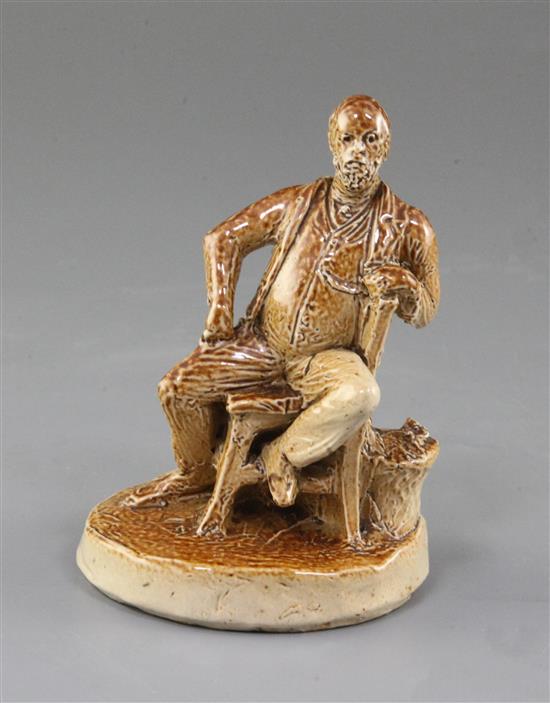 A Doulton Lambeth salt glazed stoneware figure of a seated gentleman, by George Tinworth, 10.5cm