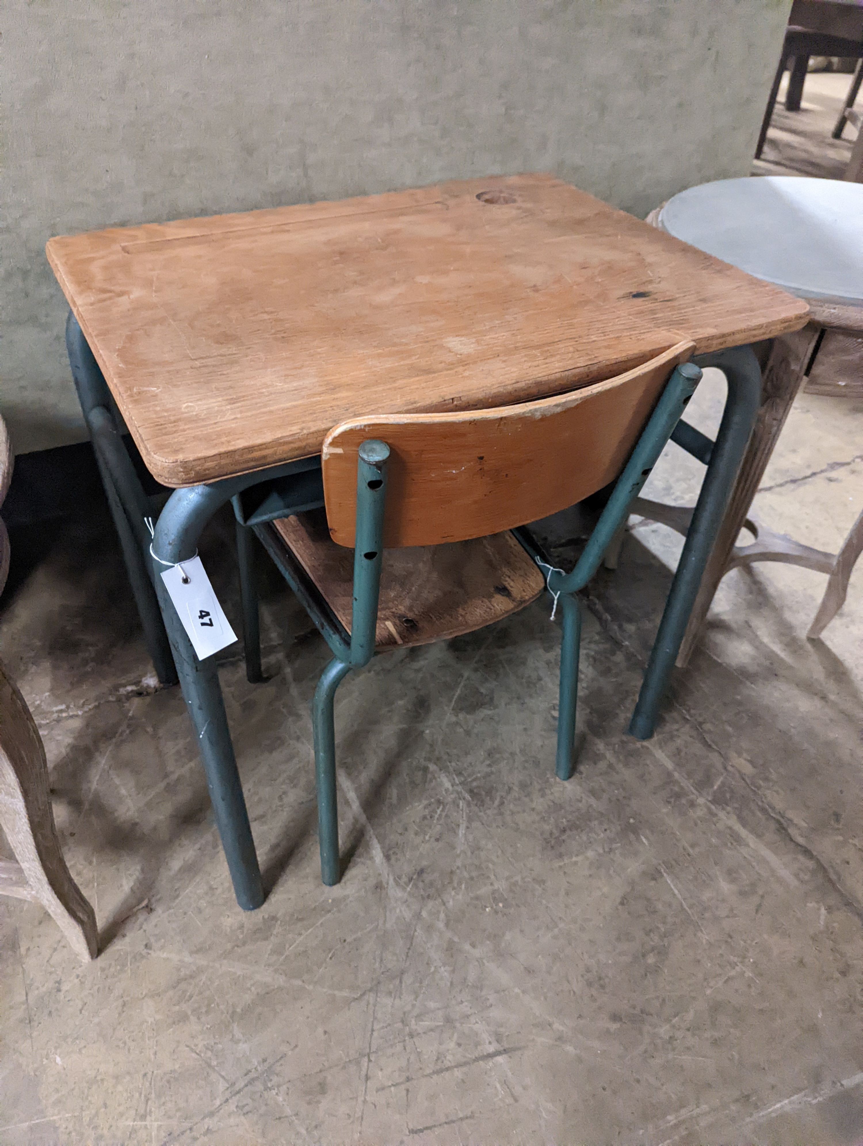 A child's oak and painted metal desk, length 59cm, depth 45cm, height 64cm and a chair