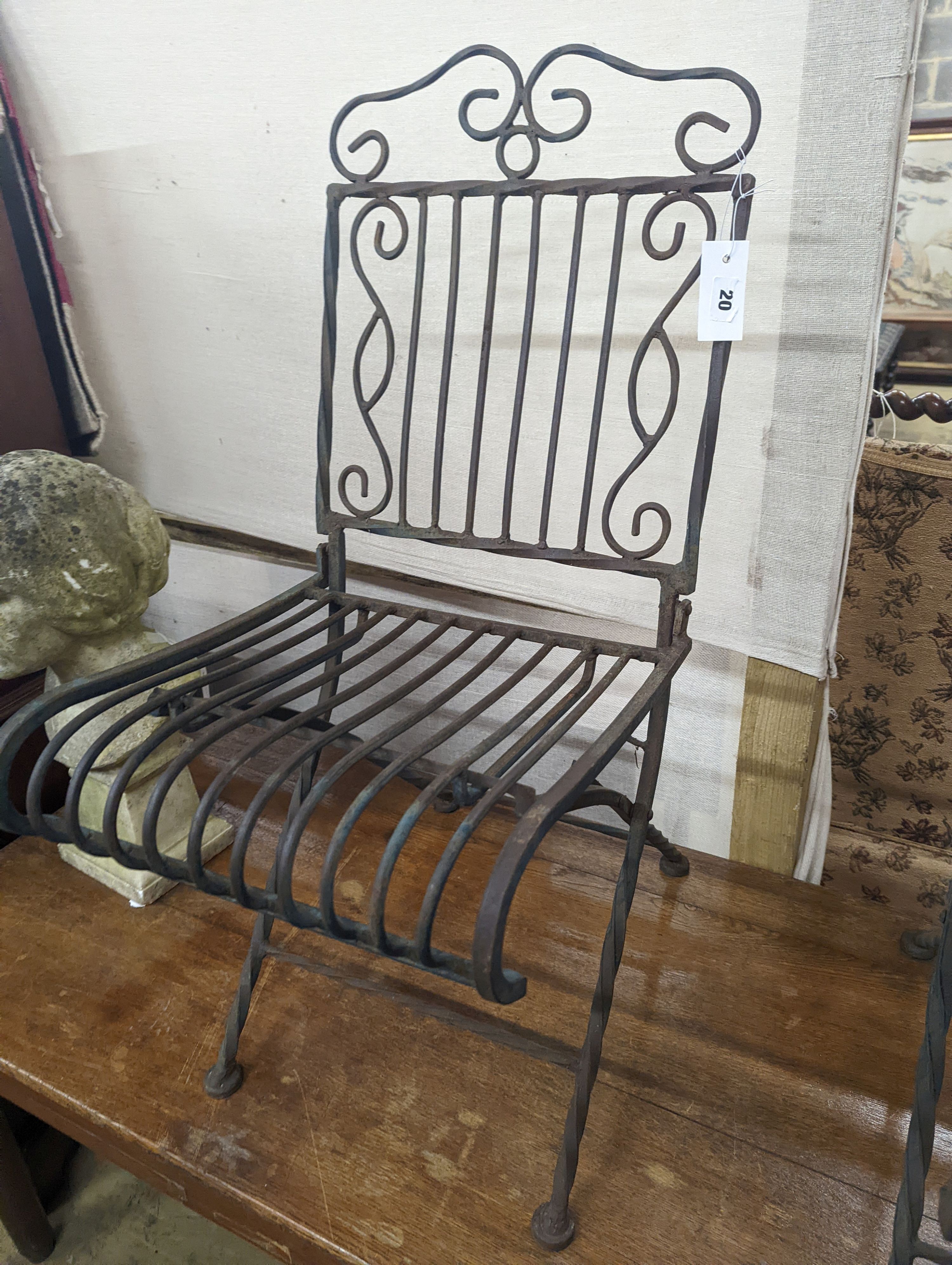 A pair of wrought iron folding garden chairs, width 38cm, height 89cm