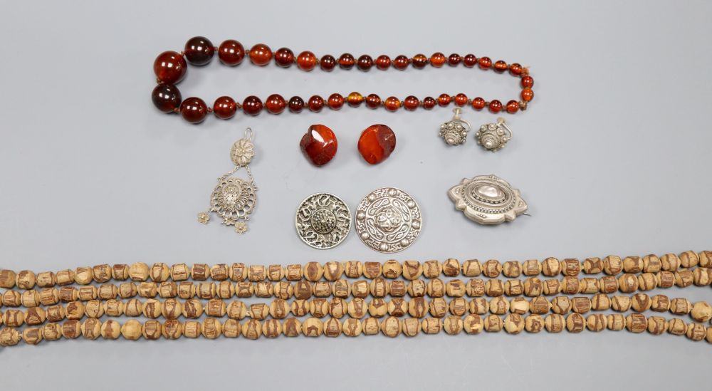 Assorted jewellery including necklaces and white metal brooches.